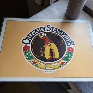 1975 CALGARY STAMPEDE PLASTIC 2-SIDED PLACEMAT EMBLEM/CHUCKWAGON RACING RARE GUC